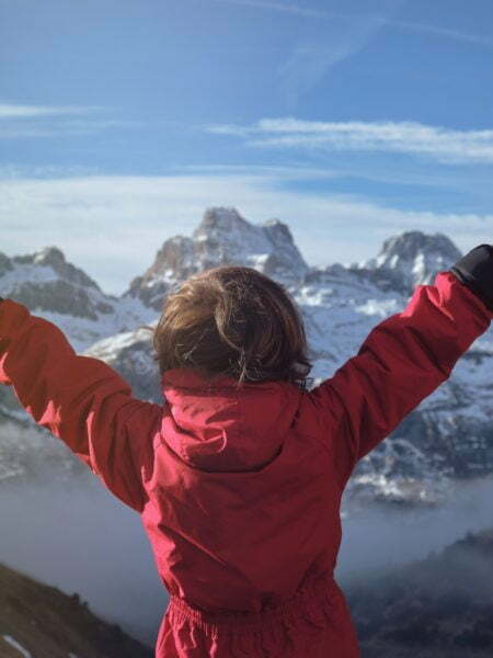Anonymous kid celebrating success in mountains What Actually Leads To Success? Request Confirmation