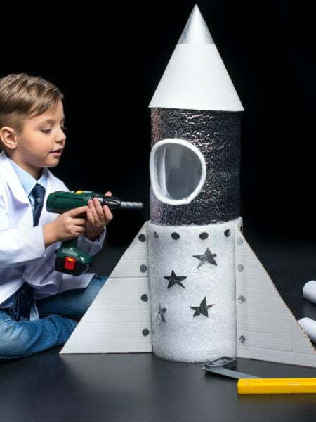 Little boy in white coat drilling toy rocket with toy drill Reach Out Into Space Donation Confirmation